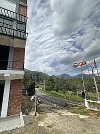 The side view features a welcoming entrance with three flags: the hotel flag and two Sri Lankan flags, reflecting our pride in local heritage.