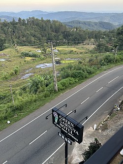 Upper view of hotel sign board and road from hotel balcony
